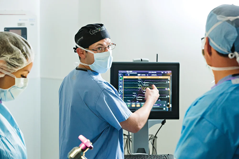 Surgeon looking at NVM5 during procedure