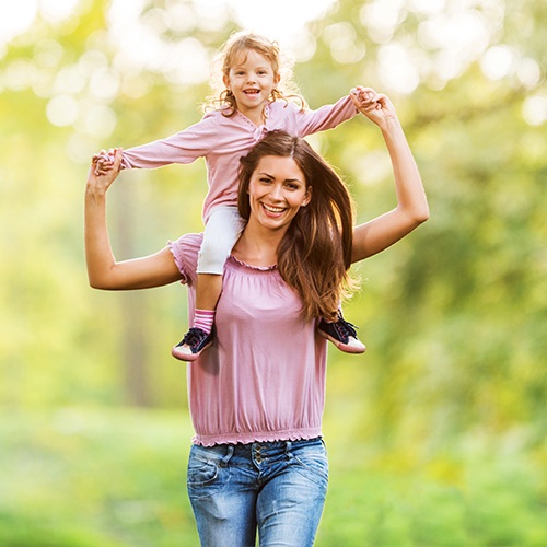 Mother with child on her shoulders