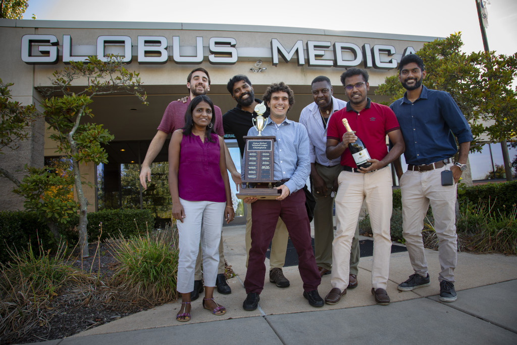 Group of people holding trophy