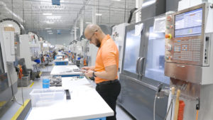 CNC Machinist holding tools