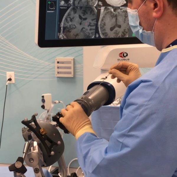 Surgeon placing navigated biopsy needle