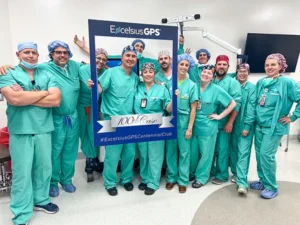 Surgical team holding up ExcelsiusGPS 100th case frame