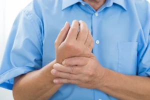 Man holding wrist in pain